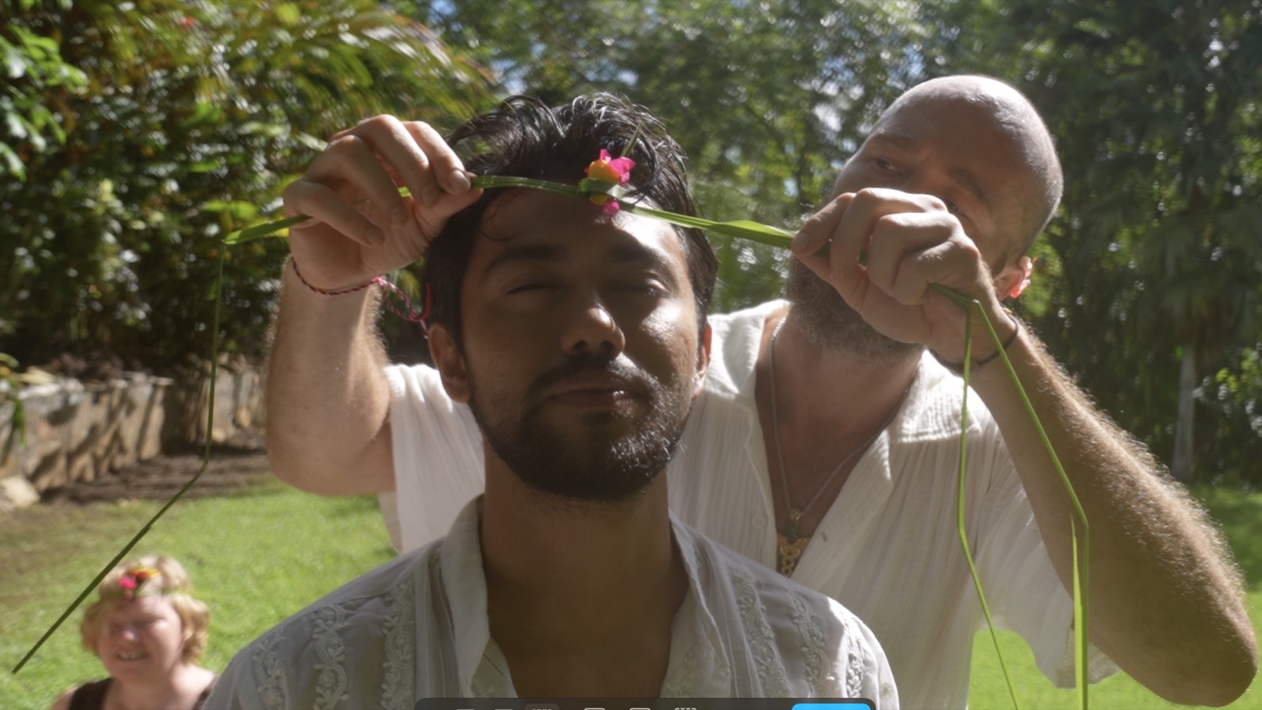 A flower crown being placed with care during ceremony