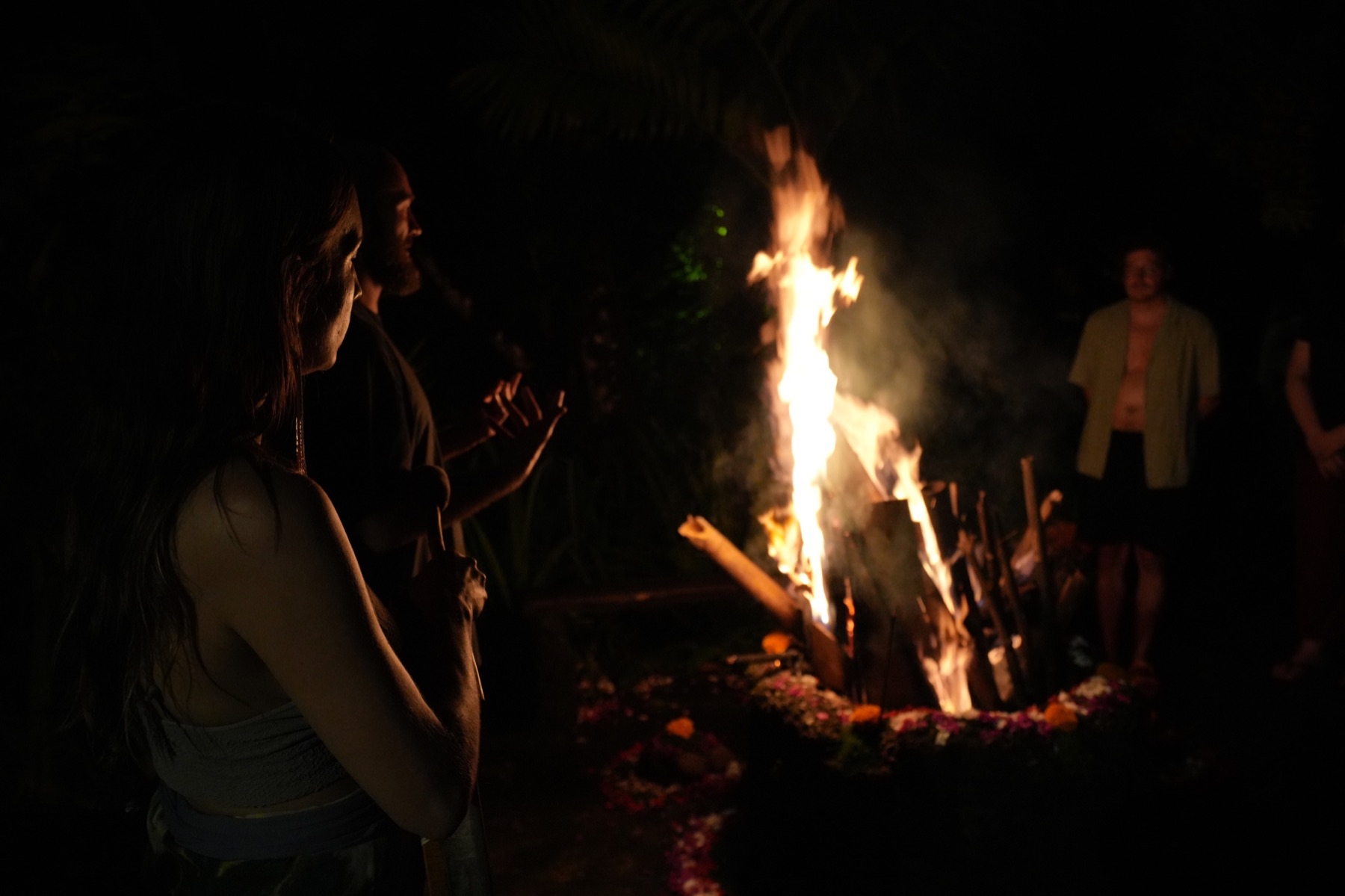 Participants gathered around the ceremonial fire at night