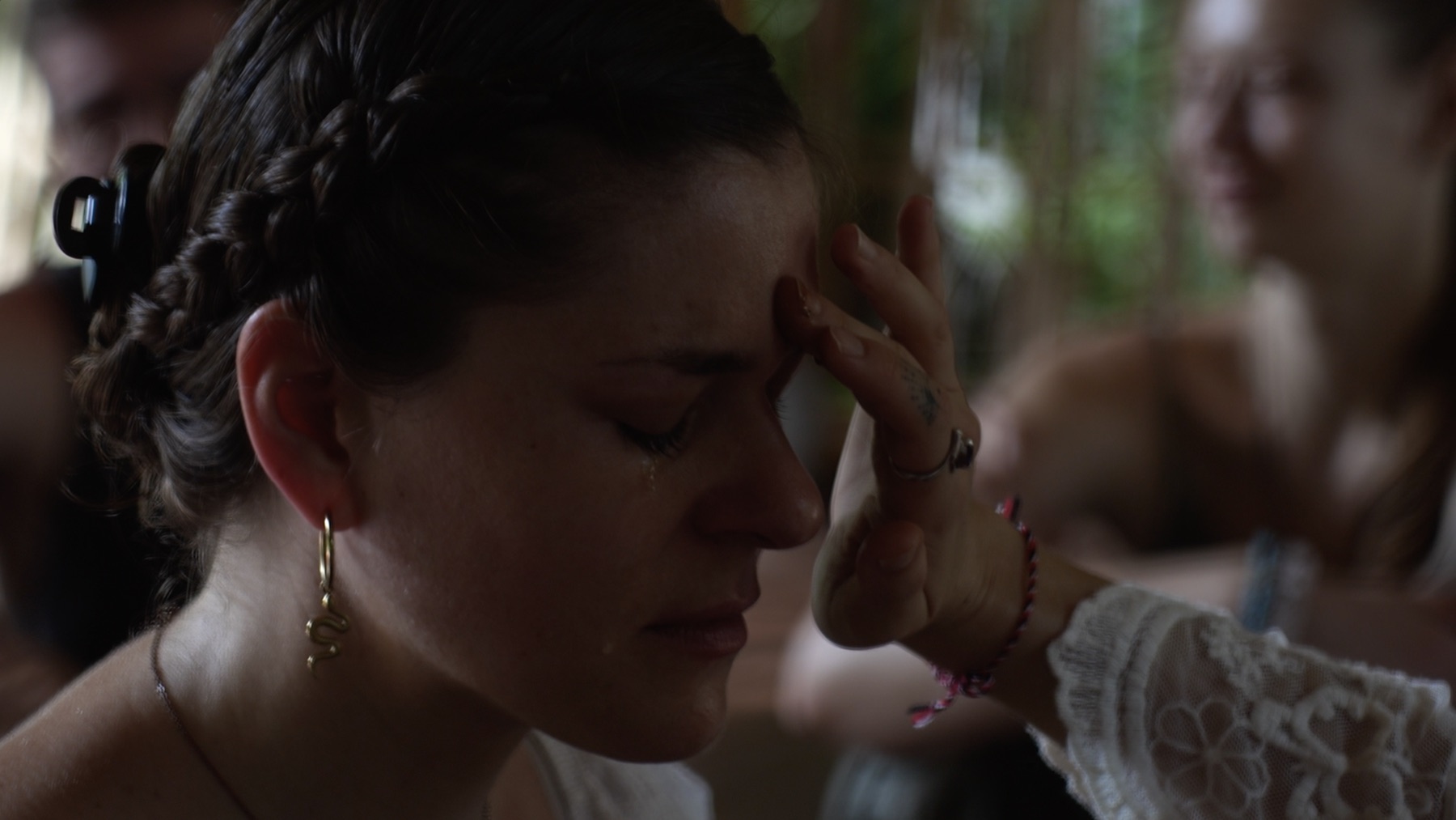 A participant being tenderly supported while emotion moves through her